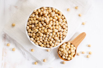 Closeup soy beans in ceramic bowl on white wooden table