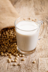 Obraz na płótnie Canvas soy beans in gunny bag and soy milk in a glass.