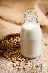 soy beans in gunny bag and soy milk in glass bottle