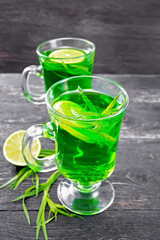 Lemonade Tarragon in two goblets on wooden board