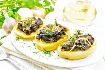 Potatoes stuffed with mushrooms on wooden board