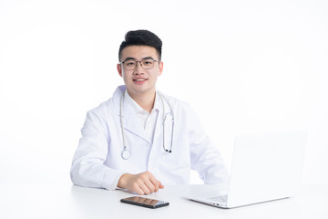 Fototapeta premium A young Asian doctor is using a device