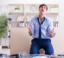 Angry businessman frustrated with too much work