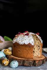 Easter composition with sweet bread, kulich and eggs on light background.