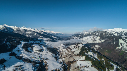 Fototapeta na wymiar aerial shot of alps in the morning with snowy peaks