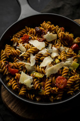 Homemade pasta with parmezan on skillet