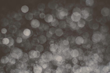 abstract white subtle bokeh bright on dark bacground for holiday , defocused image