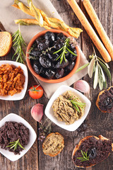olive tapenade with crackers, bread sticks and toast