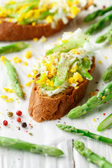 Rye bread sandwich with asparagus, feta cheese and egg. Delicious and healthy Breakfast. Bruschetta. Rustic style. Selective focus