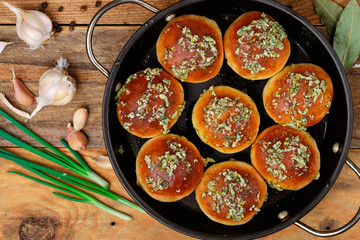 Pampushky. Traditional ukrainian homemade buns (bread) with garlic, herbs and oil. Served with borscht. Selective focus, top view