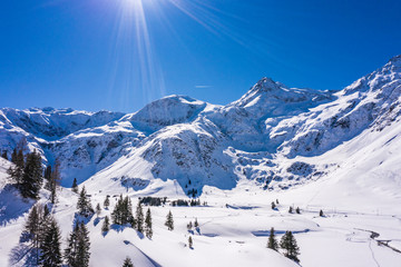 Austrian alps with snow and sun flares