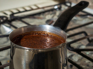 ground coffee is brewed in a steel Turk