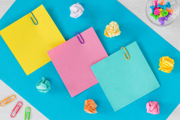 Colorful cards with space for an inscription, office or business concept, staples, crumpled balls of paper.