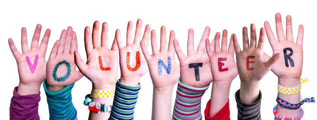 Children Hands Building Colorful Word Volunteer. White Isolated Background