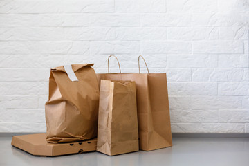 Fast food eco packaging with big lunch set of tasty hamburger, french fries, paper brown paper bag and box on the table isolated on white background
