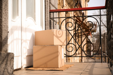 Delivered parcels on door mat near entrance