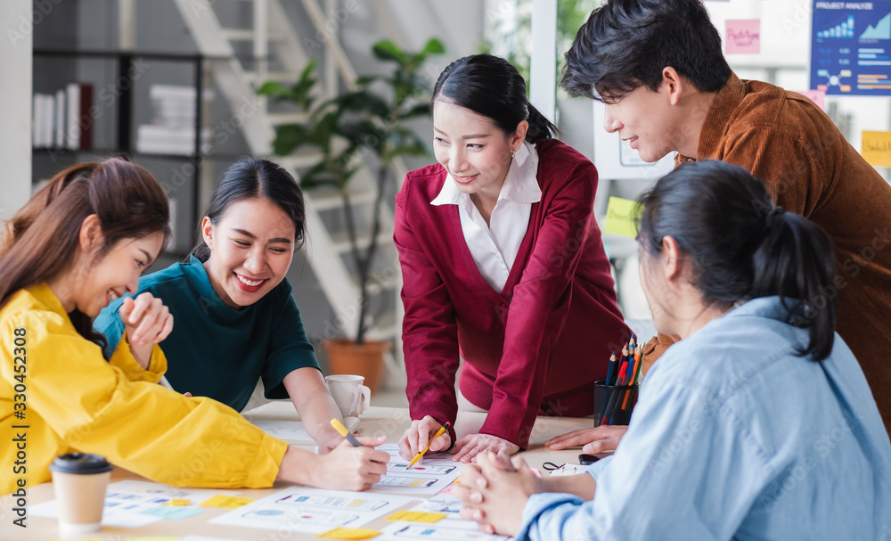 Poster ux developer and ui designer relax brainstorming about mobile app interface wireframe design on meeting table with customer brief and color code at modern office.Creative digital development agency