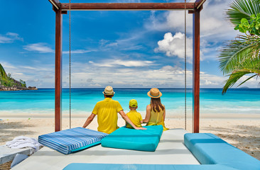 Family with three year old boy on beach. Seychelles, Mahe.