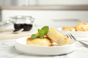 Delicious cottage cheese pancakes with mint on white marble table