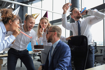 Business team celebrating a birthday of collegue in the modern office