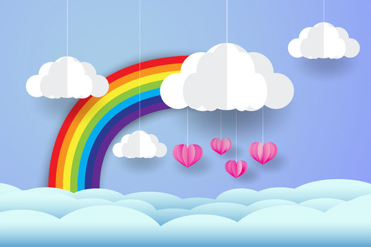 Rainbow and clouds in the blue sky, and pink heart