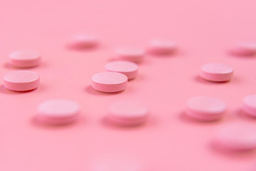 pink pills on a pink background