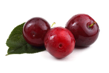 Three plums and leaf
