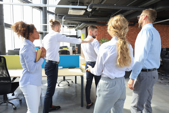 Business colleagues say goodbye to the dismissed employee