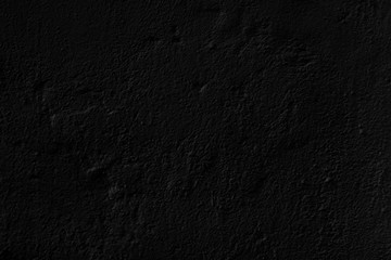 Abstract black background. Black stucco texture. Dark rough surface.