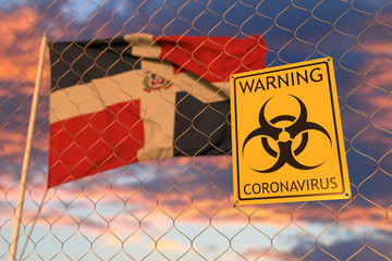 Coronavirus warning sign on the fence on the Dominican flag background. Restricted entry or quarantine in the Dominican Republic. Conceptual 3D rendering