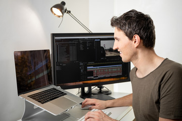 professional video editor on his desk editing an online video - obrazy, fototapety, plakaty