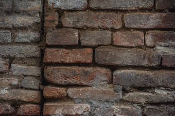 Holes in a damaged brick wall is close