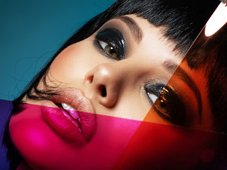 Glamour fashion model with black gloss make-up. Beautiful fashion woman with a colored items....