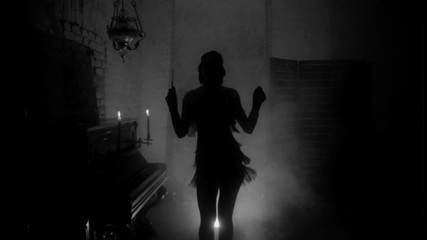 Old film style grain added. black and white color dark mysterious female silhouette. mouthpiece in hand. short sexy vintage dress 20s. retro young beautiful woman dances. backdrop room, piano, smoke