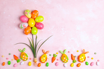 Creative holiday concept with easter eggs in shape of flower, bunny and candy