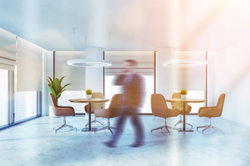 Man walking in office lounge or cafe