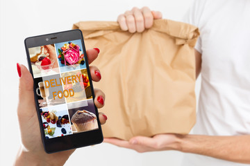 woman holding touch phone with app delivery food screen
