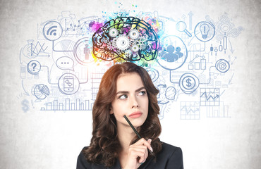 Young businesswoman with pen brainstorming