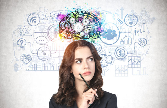 Young businesswoman with pen brainstorming