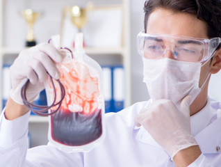 Doctor working with blood samples in hospital clinic lab
