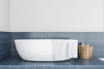 Bathtub in white and blue tile bathroom