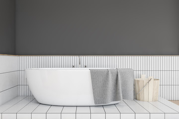 Bathtub in gray and white tile bathroom