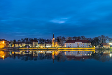 Fototapeta na wymiar City at night and its reflection in a river. Sisak, Croatia