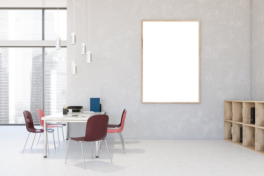 White loft office with red chairs and poster