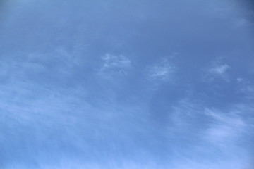 Cloudy blue sky with white and gray clouds. Background for text and design