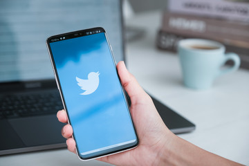 Twitter business CHIANG MAI, THAILAND - Mar 08, 2020 :Women holding Oneplus 6 with Twitter logo on the screen. Twitter is a social media online service for microblogging and networking communication.