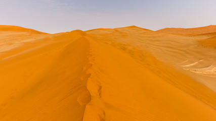footprints on the crest of a dune at Sossusvlei in Namibia