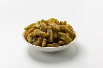The green raisins dry in the sun and stand alone on a white background