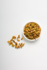 The green raisins dry in the sun and stand alone on a white background