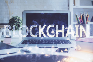 Multi exposure of blockchain and crypto economy theme hologram and table with computer background....